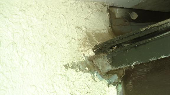 外壁確認。軒先板金とコロニアルの取り合い部分にコーキングが過剰に打たれている状態